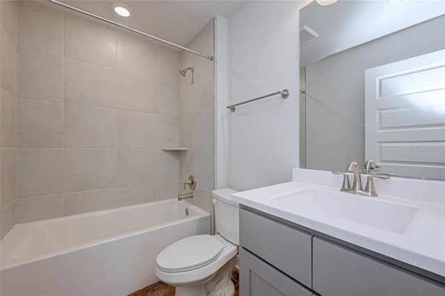 full bathroom featuring vanity, toilet, and tiled shower / bath