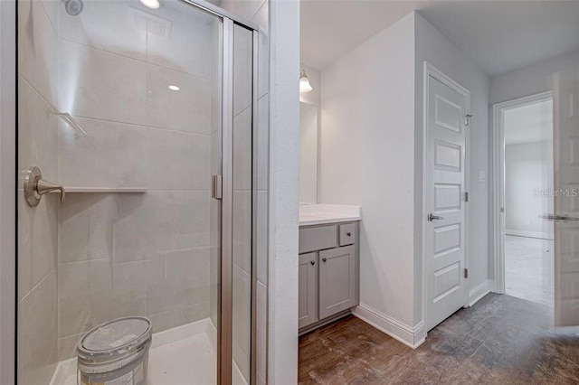 bathroom featuring vanity and a shower with shower door