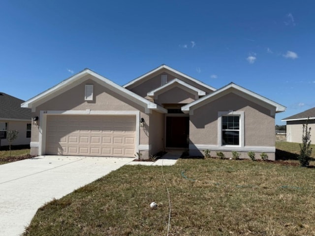 view of front of home with a front yard and a garage