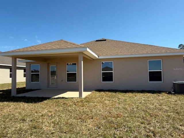 back of property with a patio, cooling unit, and a lawn