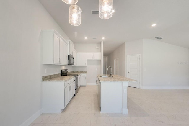 kitchen with white cabinetry, stainless steel appliances, a center island with sink, and sink