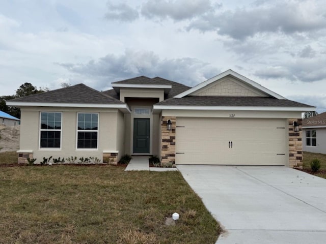 view of front of house featuring a garage, stone siding, a front lawn, and concrete driveway