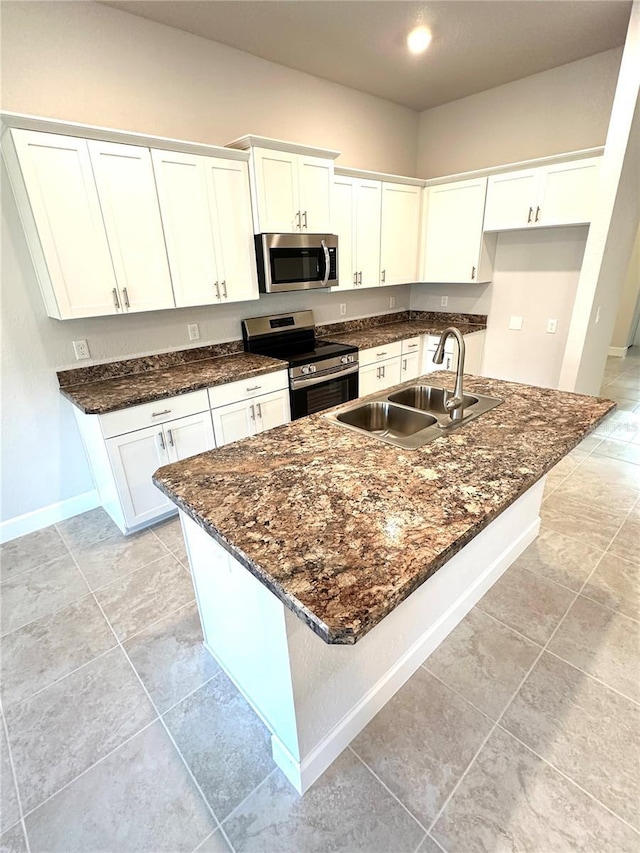 3127 NE 45th Ave, Ocala, FL 34470 - kitchen with a sink, white cabinetry, dark stone counters, and stainless steel appliances