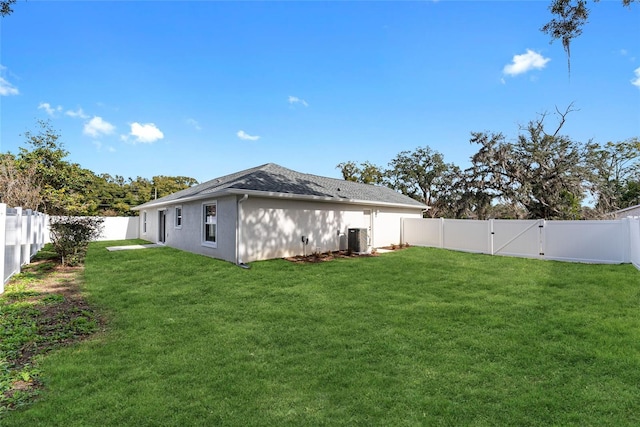 exterior space with cooling unit and a lawn