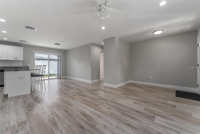 unfurnished living room featuring light hardwood / wood-style flooring and ceiling fan