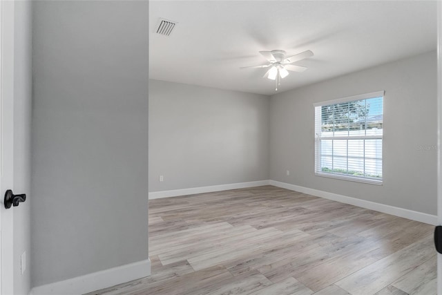 empty room with ceiling fan and light wood-type flooring