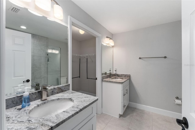 bathroom featuring vanity, an enclosed shower, and tile patterned flooring