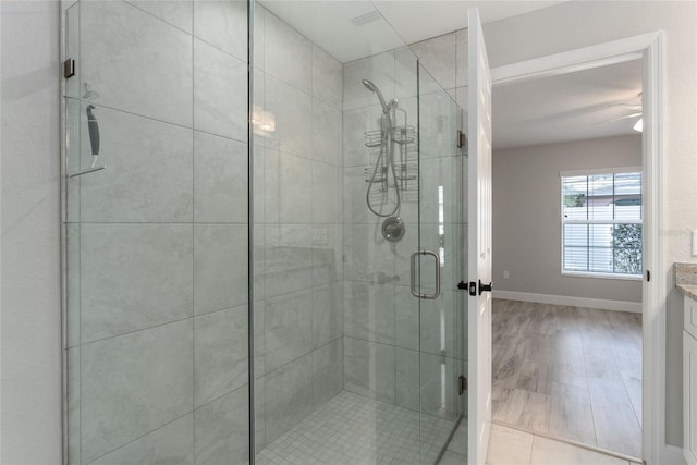 bathroom with vanity, an enclosed shower, wood-type flooring, and ceiling fan