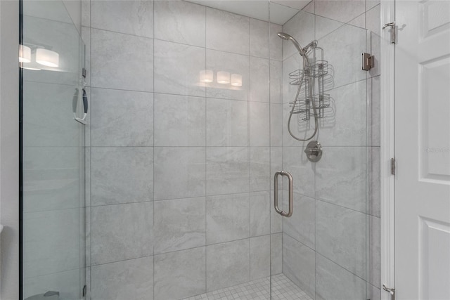 bathroom featuring a shower with door