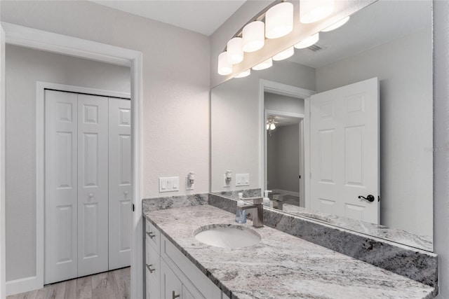 bathroom featuring vanity, ceiling fan, and hardwood / wood-style flooring