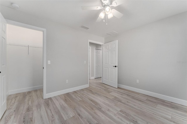 unfurnished bedroom with a closet, ceiling fan, and light hardwood / wood-style flooring