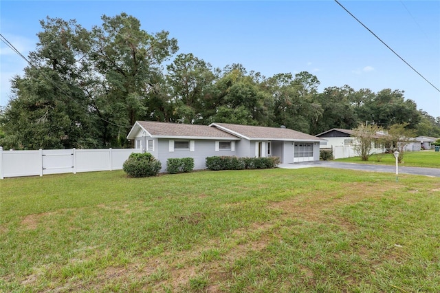 ranch-style house with a front lawn and a garage