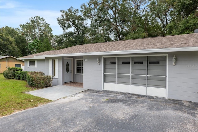 view of front of house with a front lawn and a garage