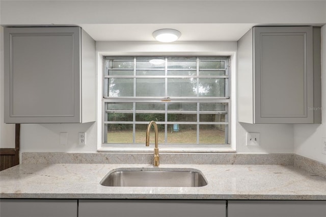 kitchen with sink, a wealth of natural light, and gray cabinetry