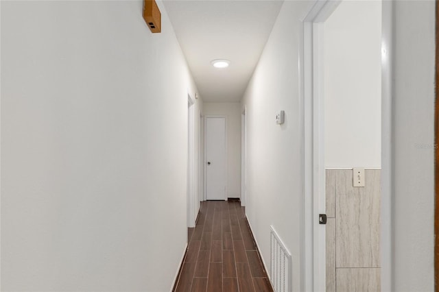 corridor featuring dark hardwood / wood-style floors