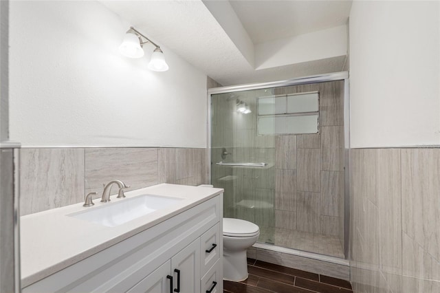 bathroom with vanity, hardwood / wood-style floors, toilet, and an enclosed shower