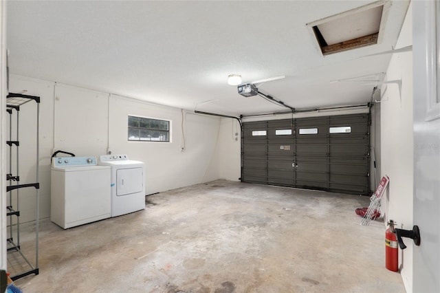 garage featuring a garage door opener and washing machine and clothes dryer