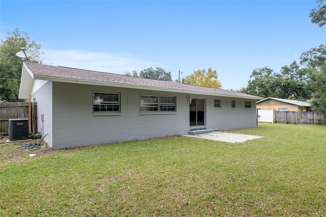 back of house featuring a patio area, central AC unit, and a lawn