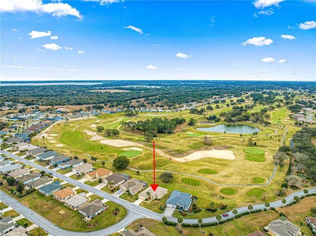 birds eye view of property featuring view of golf course, a water view, and a residential view