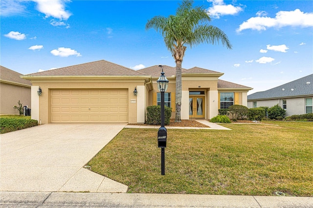 view of front of property with french doors, stucco siding, an attached garage, a front yard, and driveway