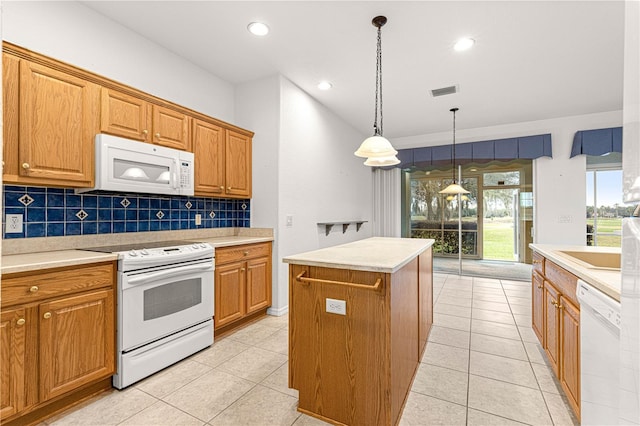 kitchen featuring light tile patterned floors, white appliances, a kitchen island, visible vents, and backsplash