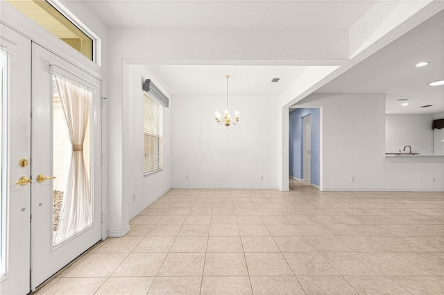 interior space featuring baseboards, recessed lighting, visible vents, and a notable chandelier