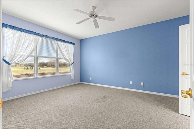 unfurnished room featuring carpet floors, baseboards, and a ceiling fan