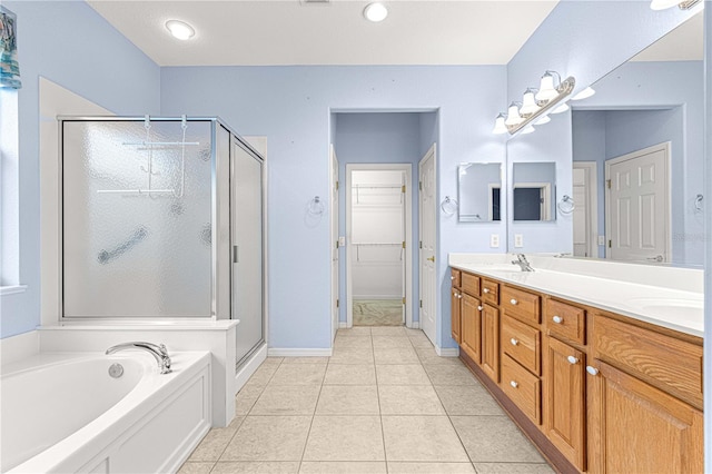 full bath with double vanity, a shower stall, a bath, and tile patterned floors