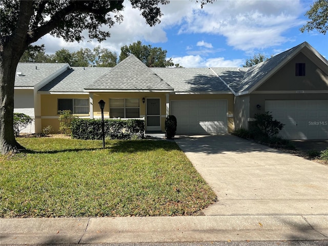 single story home with a front yard and a garage