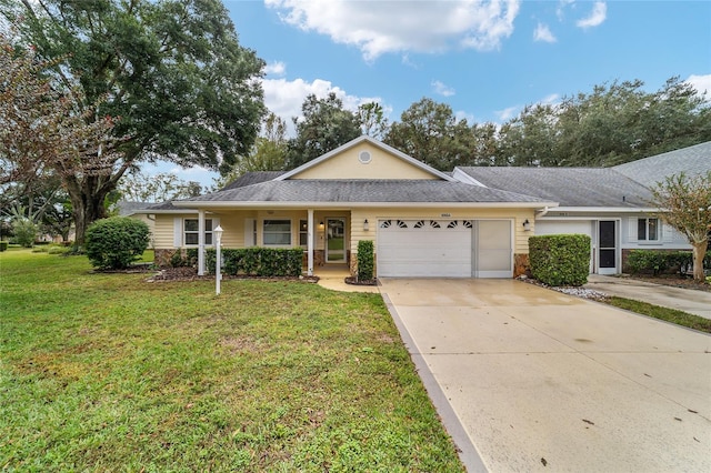 ranch-style house featuring a front lawn and a garage