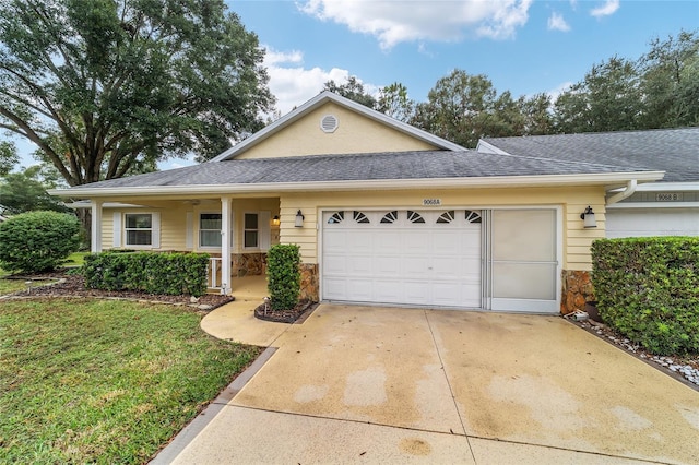 ranch-style house with a garage and a front lawn