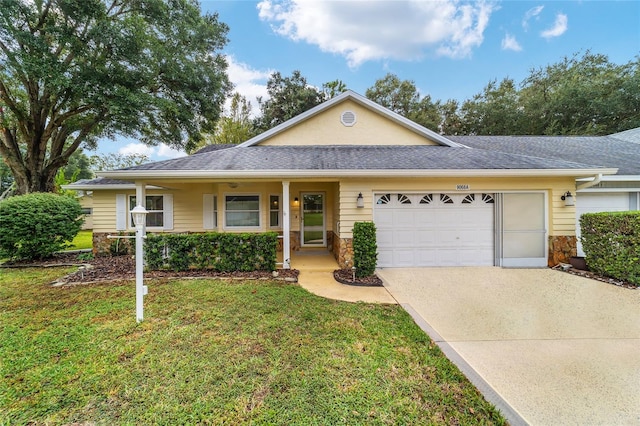 single story home with a garage, a front yard, and covered porch