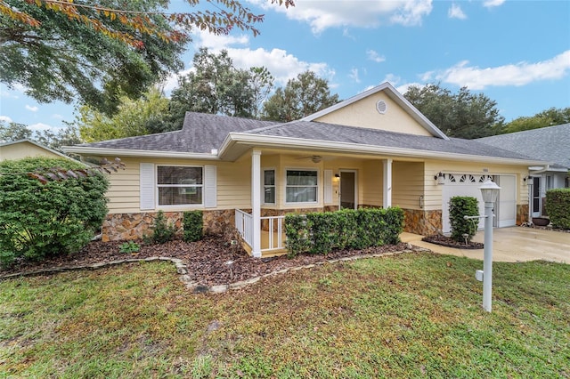 view of front of house featuring a garage, a porch, and a front yard