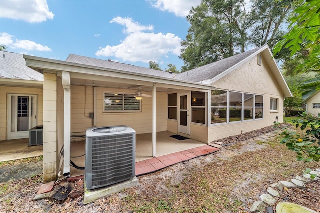 back of property featuring central air condition unit, ceiling fan, a sunroom, and a patio area