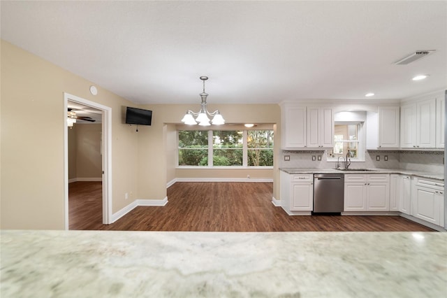 kitchen featuring dark wood-type flooring, pendant lighting, sink, white cabinets, and dishwasher