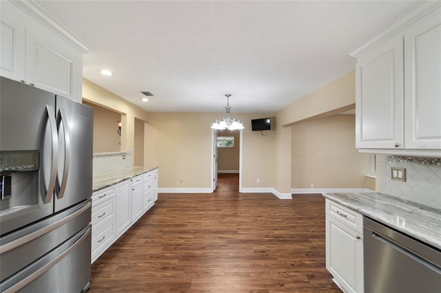 kitchen with appliances with stainless steel finishes, dark hardwood / wood-style floors, backsplash, a chandelier, and white cabinets