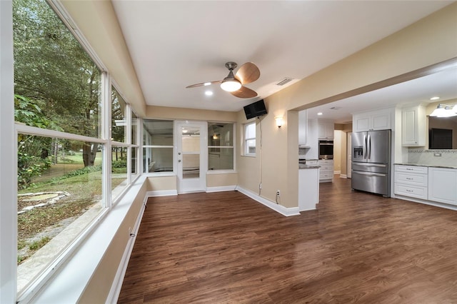 interior space featuring white cabinetry, appliances with stainless steel finishes, decorative backsplash, and dark hardwood / wood-style floors