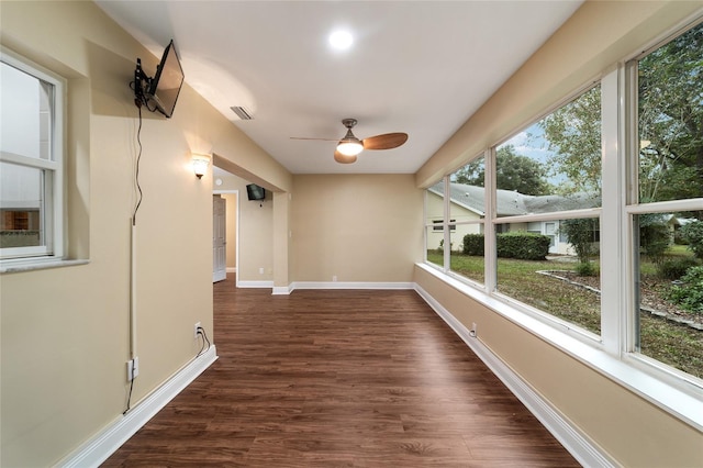 unfurnished sunroom featuring ceiling fan