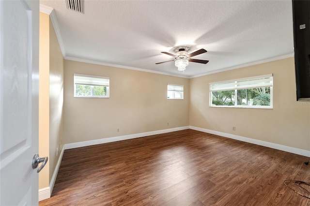 spare room featuring a wealth of natural light, dark hardwood / wood-style floors, and crown molding