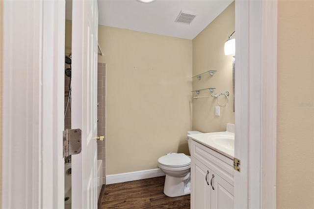 full bathroom with hardwood / wood-style flooring, vanity, toilet, and tub / shower combination