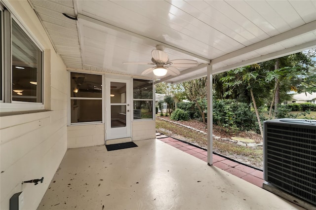 unfurnished sunroom with ceiling fan