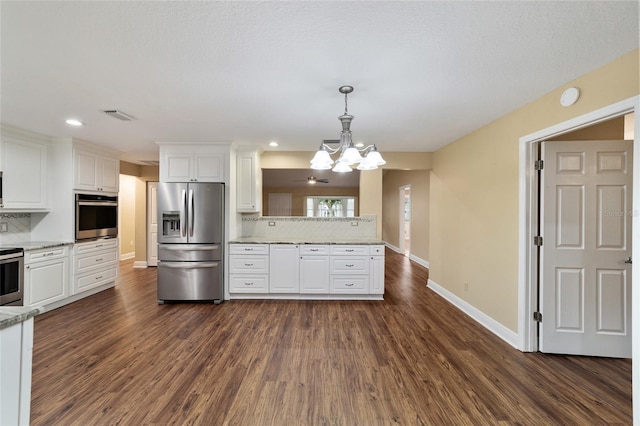 kitchen with pendant lighting, stainless steel appliances, white cabinets, dark hardwood / wood-style flooring, and decorative backsplash