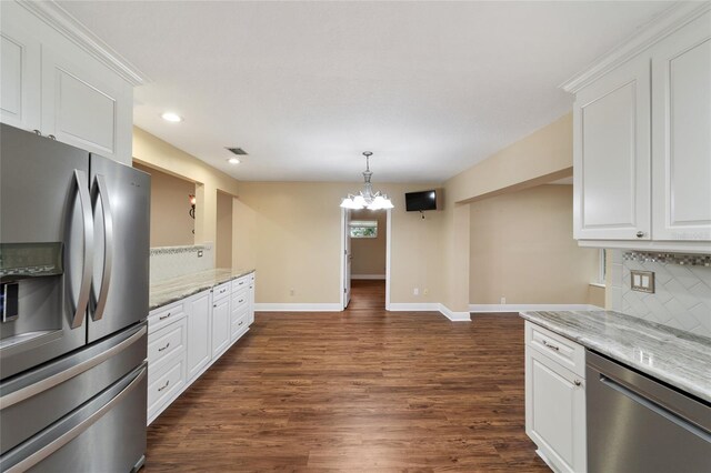 kitchen featuring light stone counters, tasteful backsplash, white cabinets, and appliances with stainless steel finishes