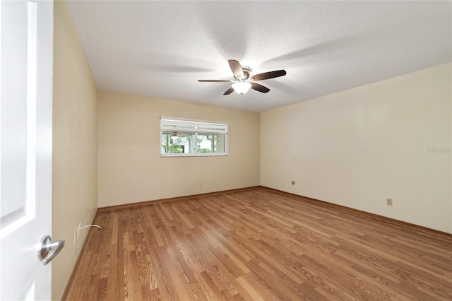 unfurnished room featuring ceiling fan, a textured ceiling, and light wood-type flooring