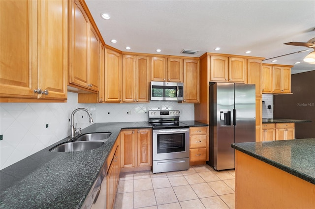 kitchen featuring tasteful backsplash, sink, ceiling fan, stainless steel appliances, and light tile patterned floors