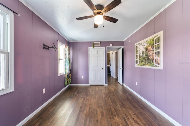 unfurnished bedroom with ceiling fan, crown molding, and dark hardwood / wood-style floors