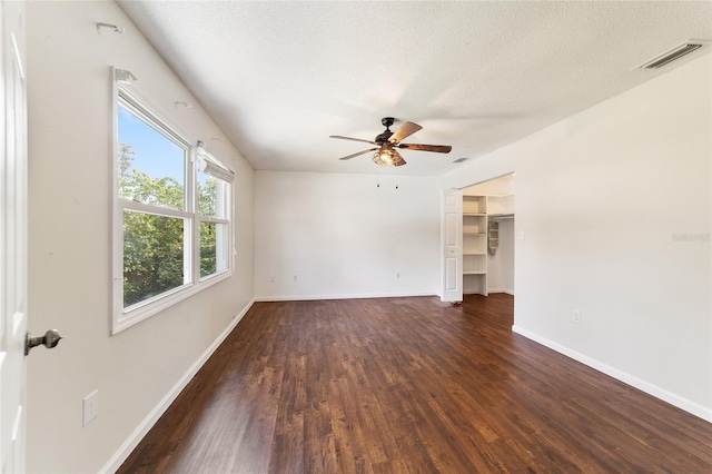 spare room featuring ceiling fan, a textured ceiling, and dark hardwood / wood-style floors