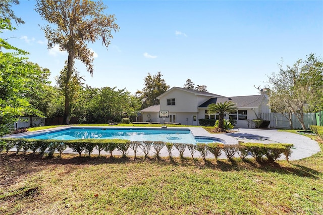 view of swimming pool with a patio and a lawn