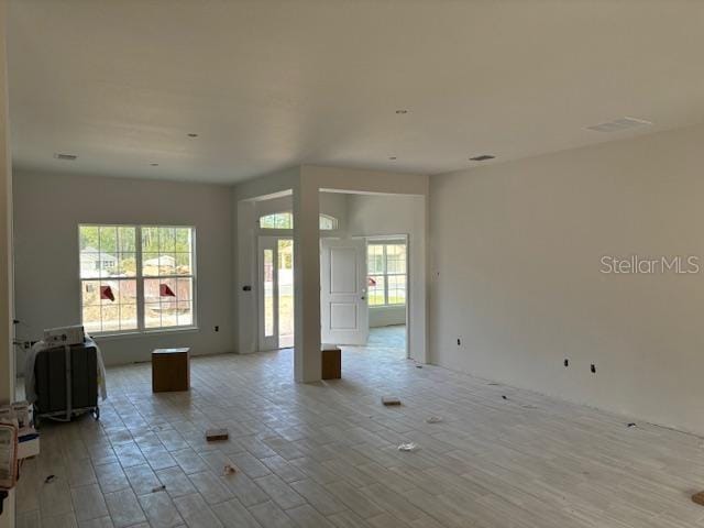 unfurnished living room with light hardwood / wood-style flooring