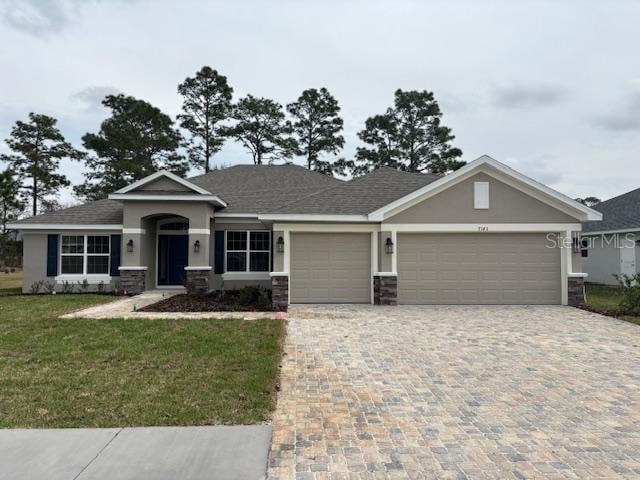 view of front of house with a front yard and a garage